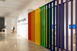 Queer Miami exhibition | Title wall and rainbow panel installation